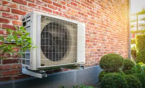 mounted heat pump outside or red brick house