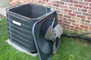 air conditioner with condenser fan leaned against it