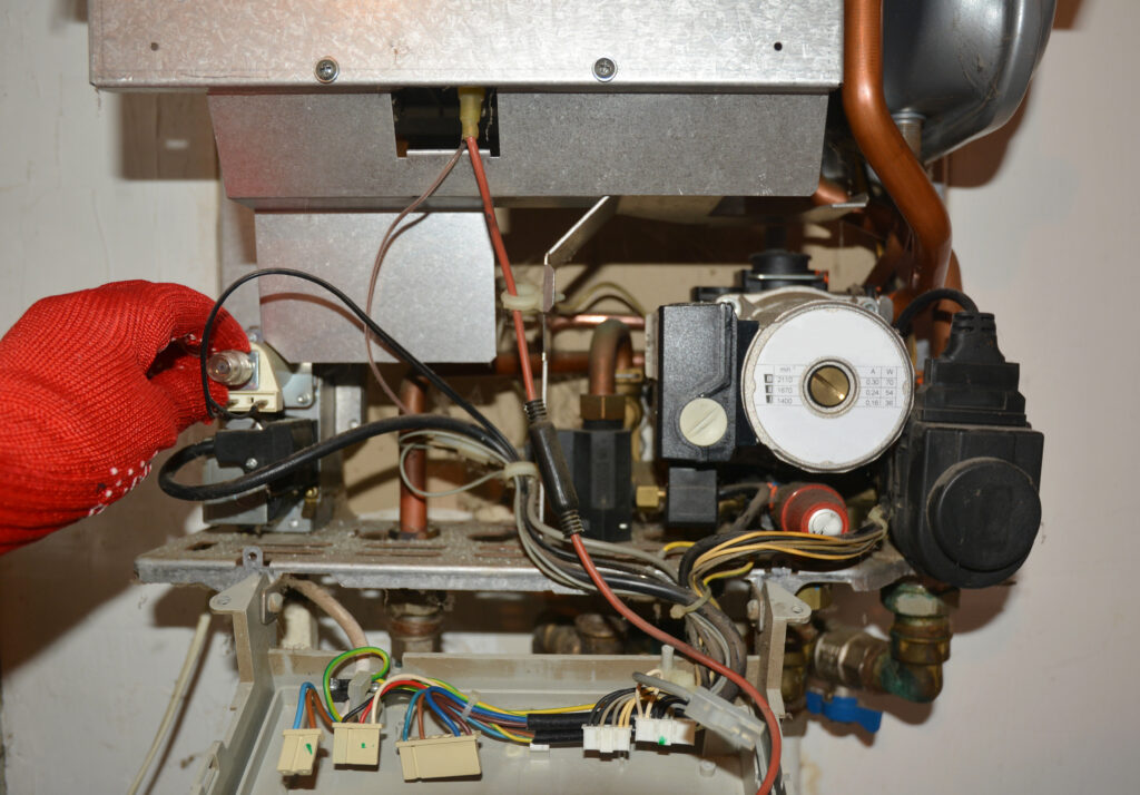 Technician servicing a gas boiler