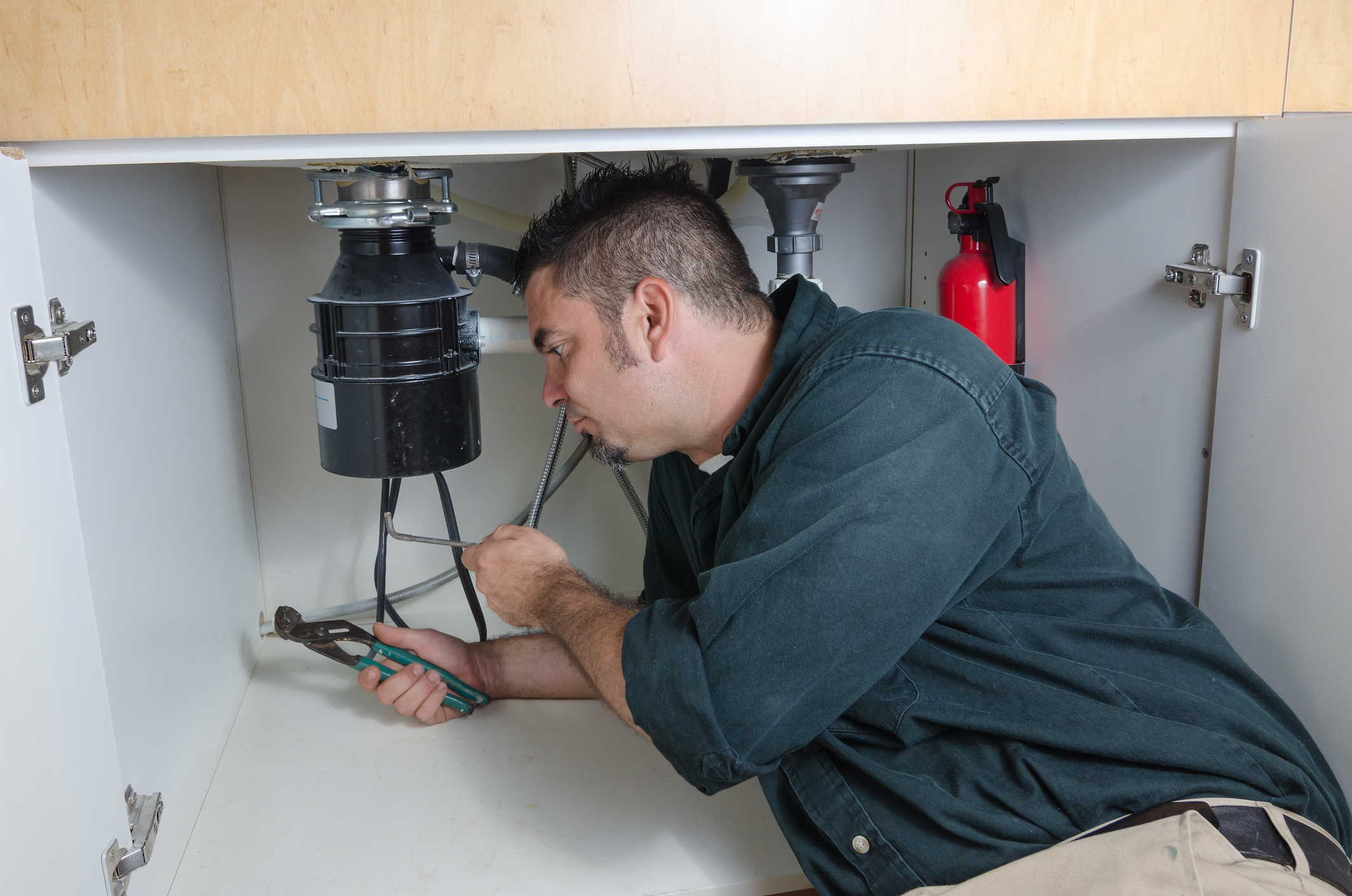 Using an allen wrench key to reset garbage disposal 